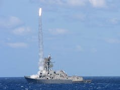 US Carrier Strike Group conducts live fire missile exercise en route to Middle East