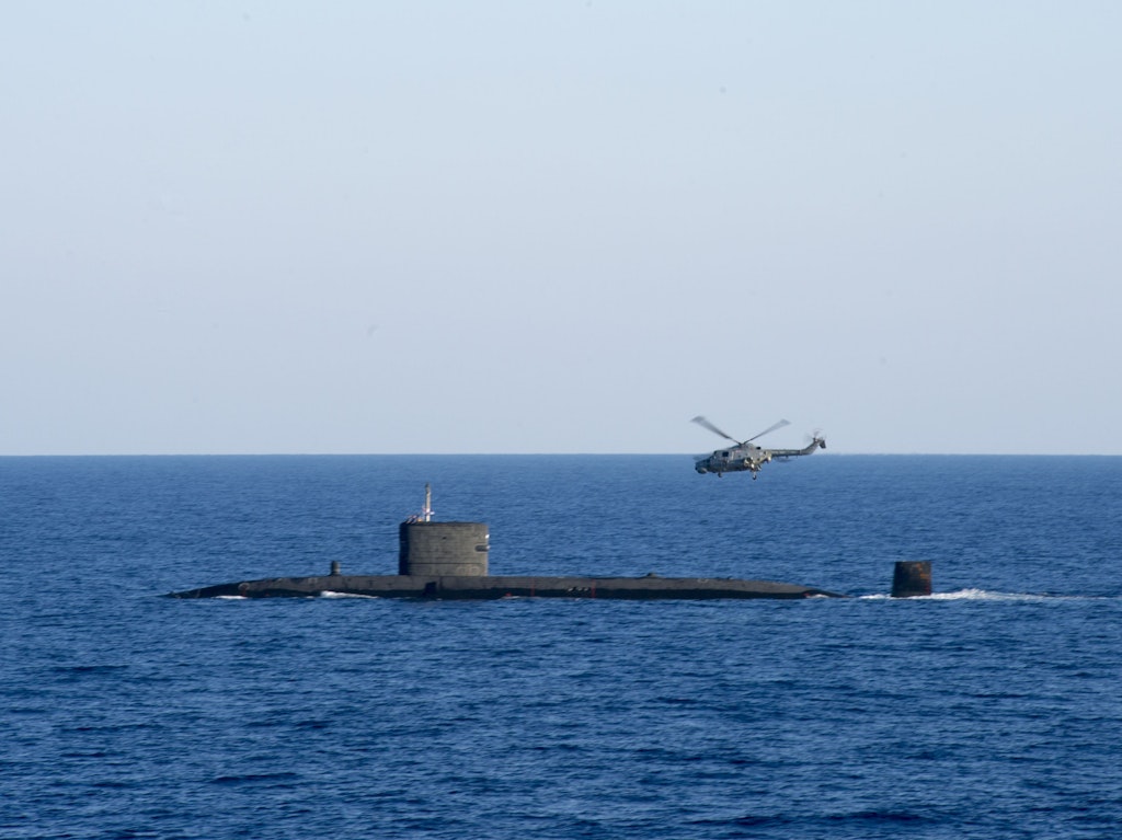 HMS Talent with a Lynx helicopter in the Mediterranean Sea.