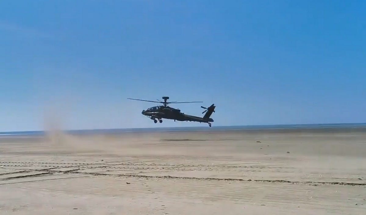Apache attack helicopters practise beach landings