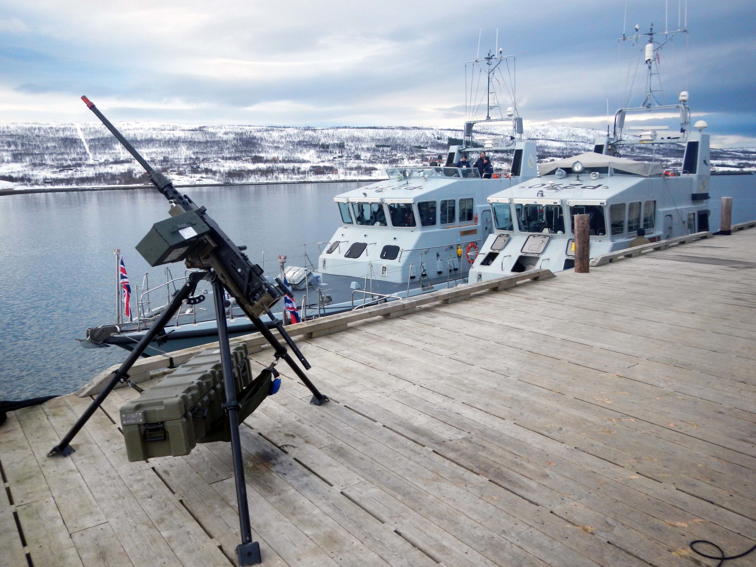 HMS Astute Returns To Operations   HMS Biter Nearest The Jetty And Blazer Alongside In The Arctic And A Machine Gun 1 Scaled 