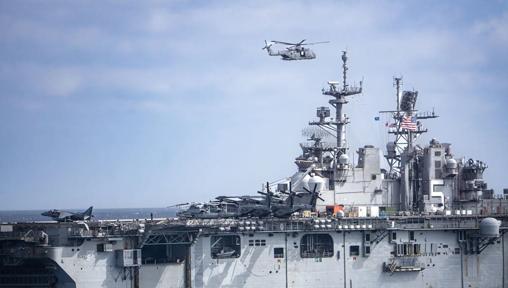 A Merlin passes over the USS Bataan