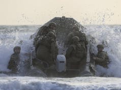 Commandos conduct surf drills for raiding operations