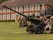Britain’s King Charles fires artillery