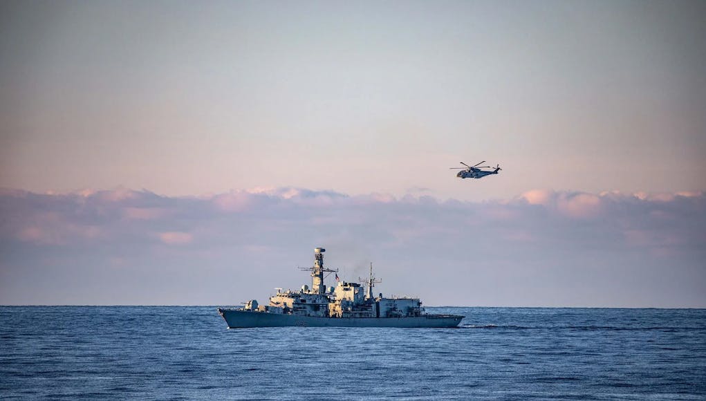 HMS Somersets Merlin makes a pass of the ship during Ex Arctic Dolphin