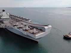 Drone shows British aircraft carrier arrive in Australia