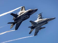 UK and US carrier jets fly in tight formation over Pacific