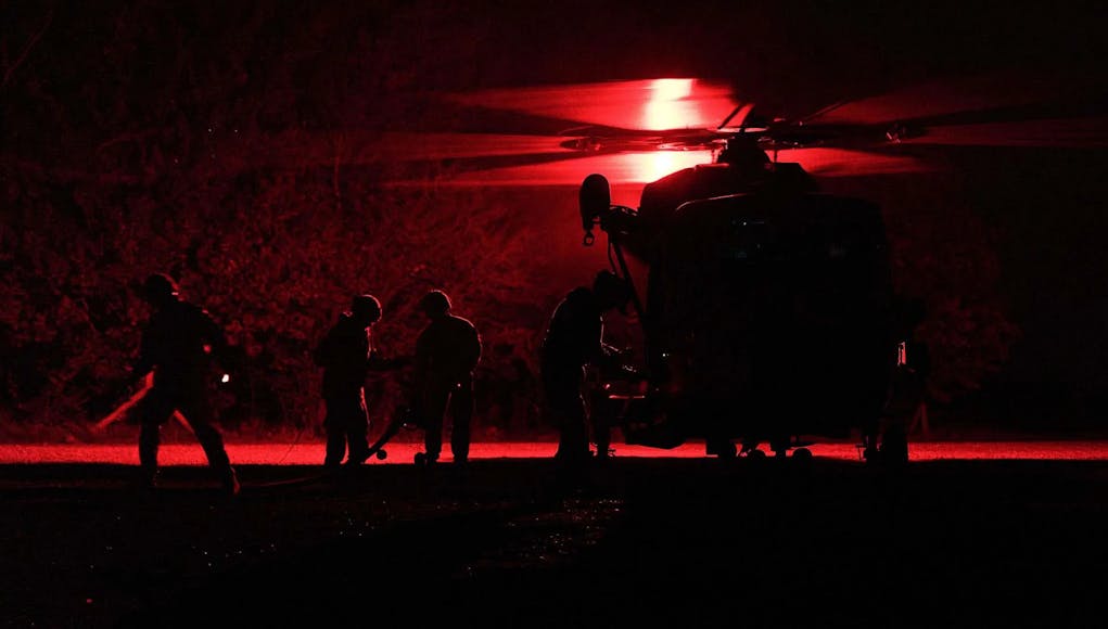 A Commando Wildcat is refuelled at night at a forward base on Salisbury Plain