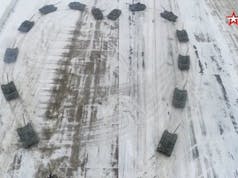 Russian soldier rolls out tanks for romantic maneuver
