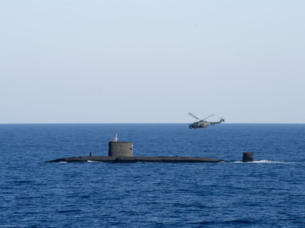 HMS Talent with a Lynx helicopter in the Mediterranean Sea.